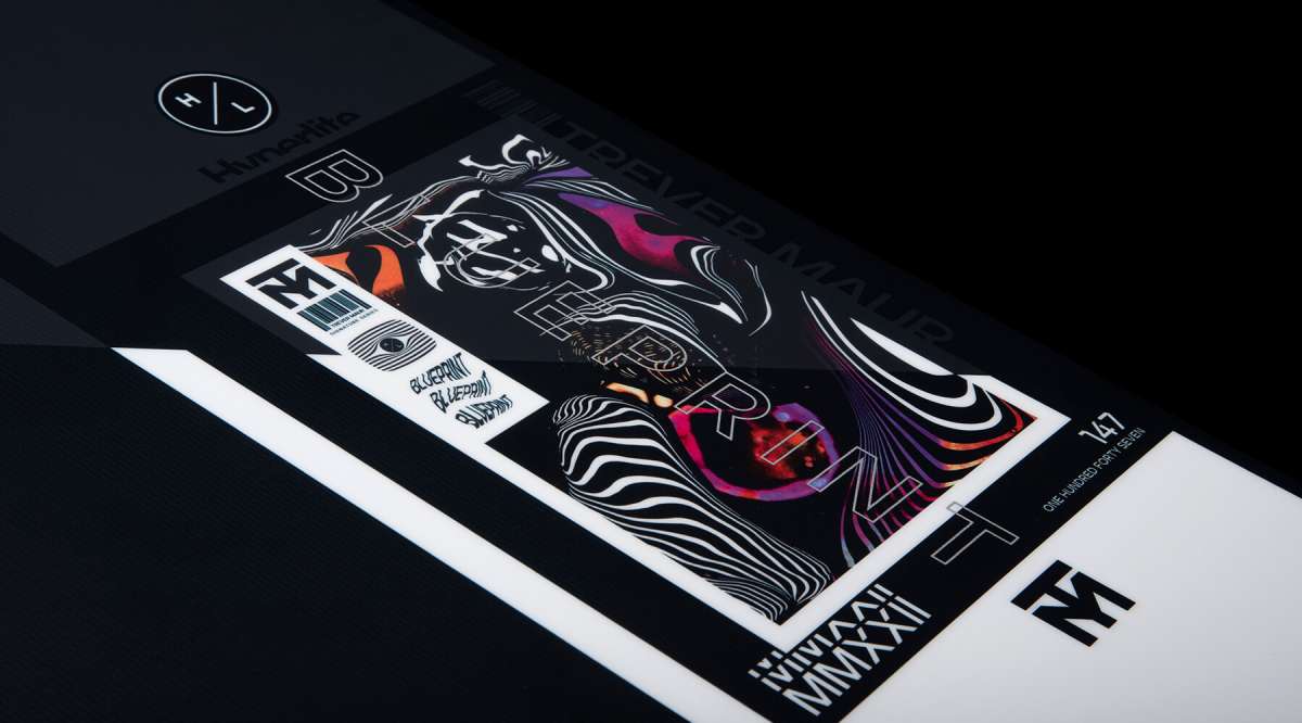 Hyperlite Trever Maur Blueprint Wakeboard 2022 - A black wakeboard with a white and orange logo on top, featuring a blue outline of a man's head.