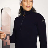 Icepeak Ladies Evansdale 1/4 Zip Top 2022-2023 - A navy-blue zip-up top with a high collar and zipper that runs from the neck to the chest, worn by a woman.