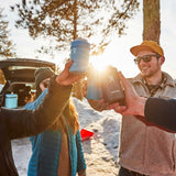 Hydro Flask 12oz Cooler Cup - A blue cooler cup with a white logo on the side, held by someone wearing a brown jacket and black sunglasses.