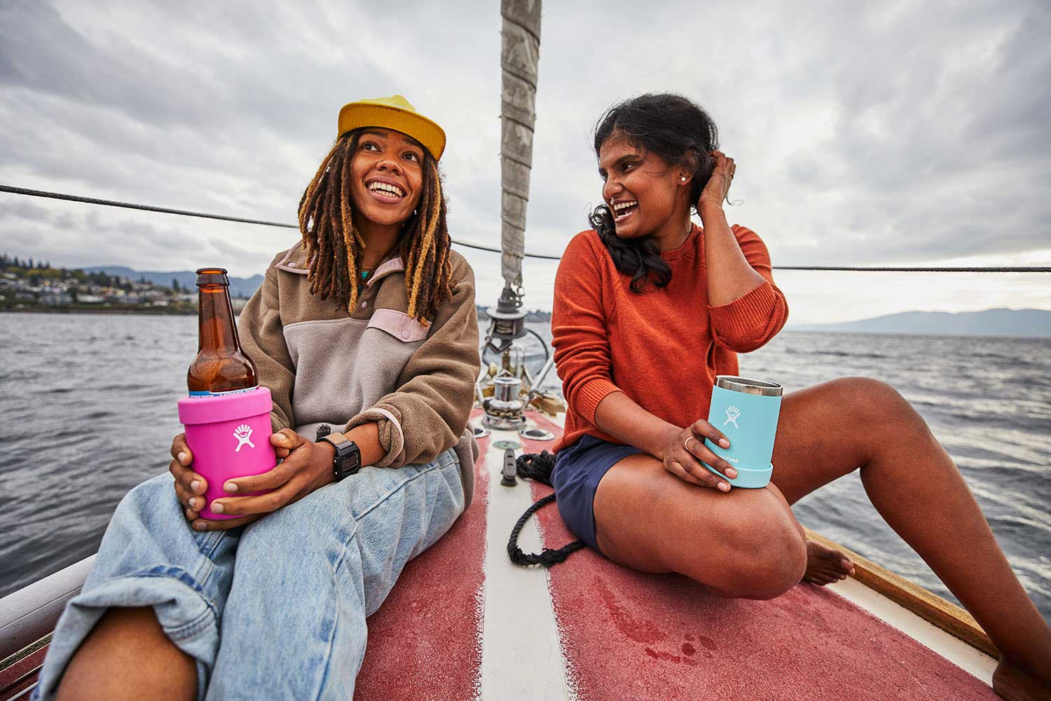 Hydro Flask 12oz Cooler Cup - A blue cooler cup with a white logo on the front, featuring a screw-on lid and a handle on one side.