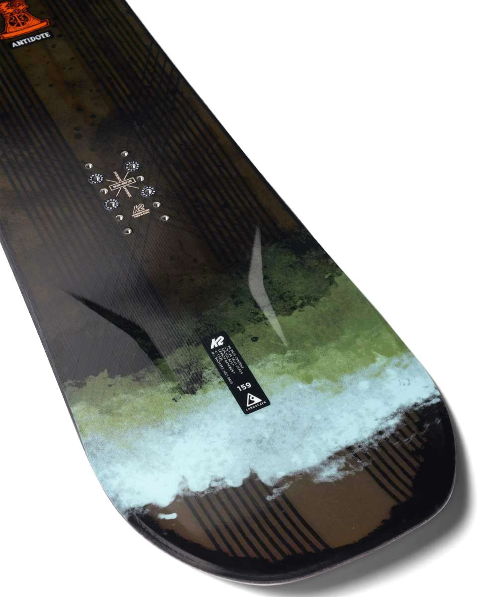 K2 Antidote snowboard features a white base with blue and black graphic details.