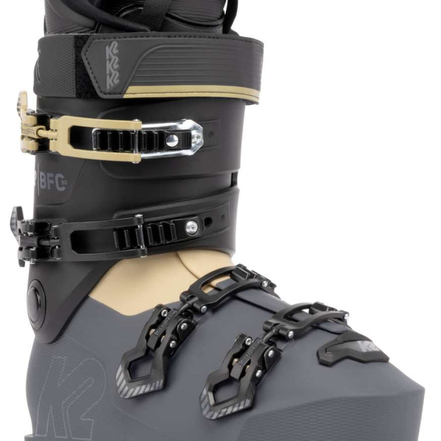 The K2 BFC 90 GW Ski Boot for the 2021-2022 season is a black and gray boot with a gold buckle, featuring a sturdy design with straps and a high top.