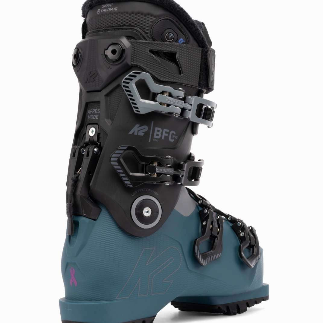 The K2 Ladies BFC 95 Heat GripWalk Ski Boots are a pair of boots designed for women, featuring a black and white color scheme. They have a heat grip sole that provides better traction on snowy surfaces. The boots are equipped with buckles for adjusting the fit and straps for securing the foot in place. The K2 logo is visible on the side of the boot, indicating the brand. These ski boots are likely to be used by women who enjoy winter sports like skiing or snowboarding.