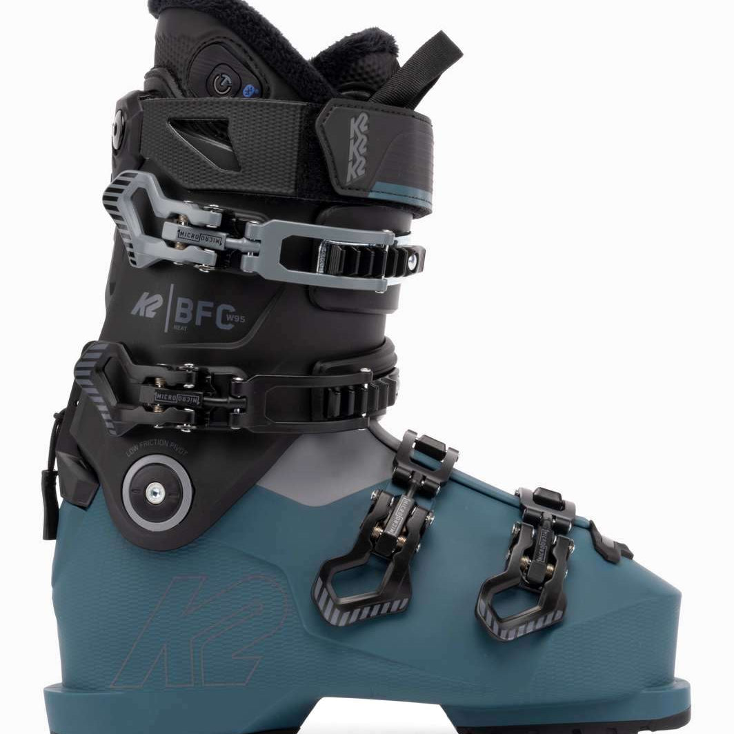 The image shows a pair of K2 Ladies BFC 95 Heat GripWalk Ski Boots for the 2021-2022 season. The boots are gray and blue in color, with black straps and buckles. They feature a heat grip sole for better traction on snowy surfaces.