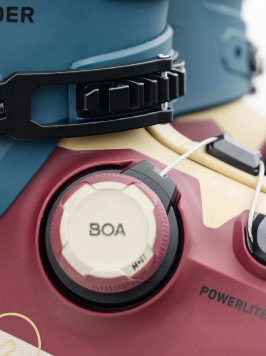 K2 Mindbender 95 BOA ski boot features a red and black color scheme with a visible BOA dial.