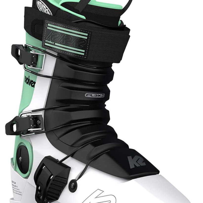 White K2 Revolver ski boots feature green accents and black hardware.