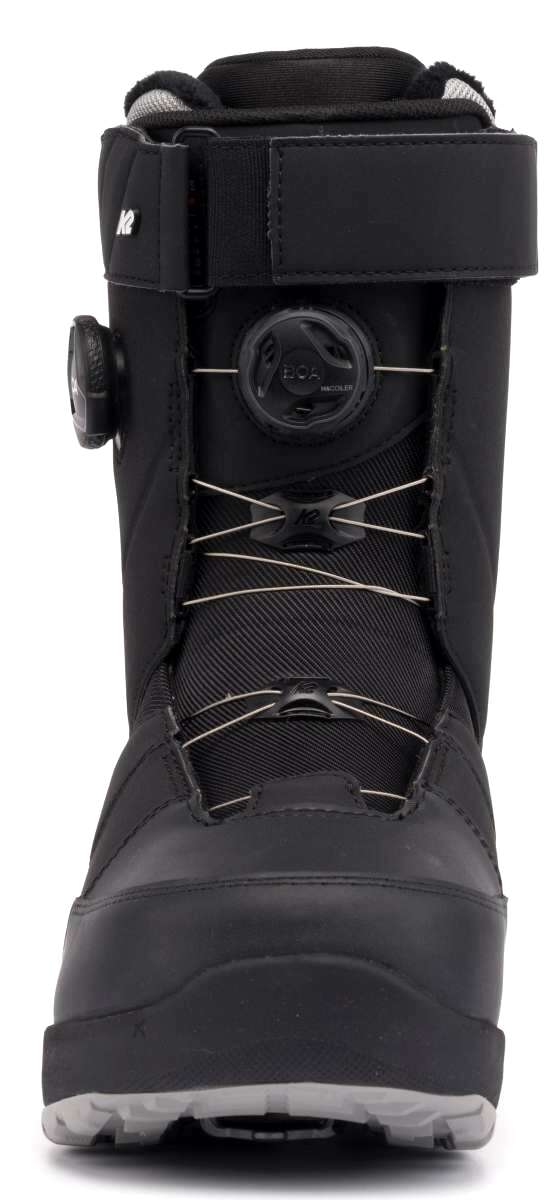 The K2 Maysis Clicker X HB Snowboard Boot is a black and white snow boot with a buckle closure system. It features a sturdy design, suitable for winter sports like skiing or snowboarding. The boot has a lace-up front and a pull tab on the back for easy entry.