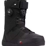 The image shows a pair of black snowboard boots with a white logo on the side. The boots have a thick, insulated design and are equipped with a buckle closure system for secure fit. They also feature a sturdy rubber sole for grip and durability.