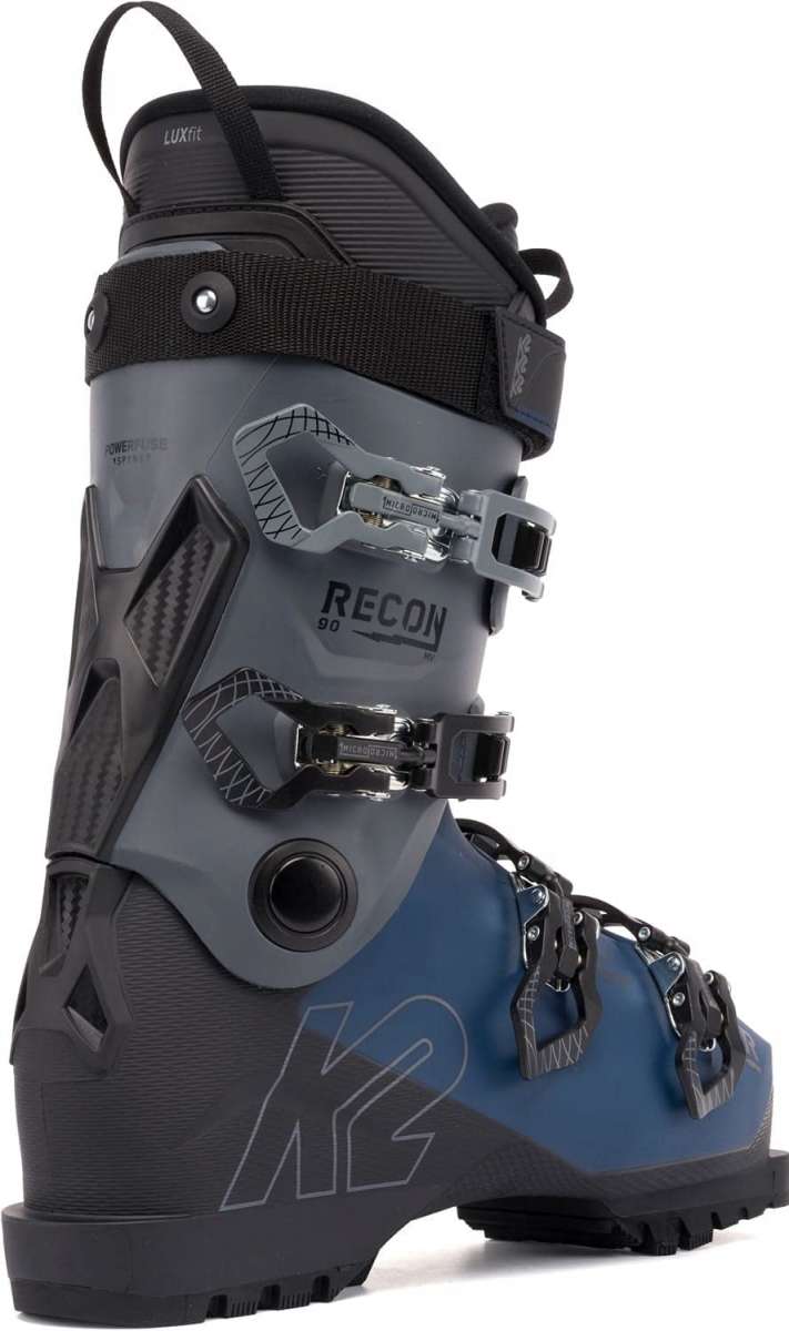 The image shows a pair of K2 Recon 90 MV ski boots for the year 2023. The boots are gray and black, featuring a BOA closure system and a sturdy design suitable for winter sports activities.