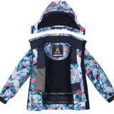 Kamik Junior's Tallie Floressence Jacket 2024 - A blue and pink floral patterned jacket with a hood, featuring a navy lining.