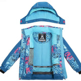 Kamik Girls Koko Insulated Jacket 2024 - A blue and pink snowflake patterned jacket with a hood, featuring a zipper closure on the front.