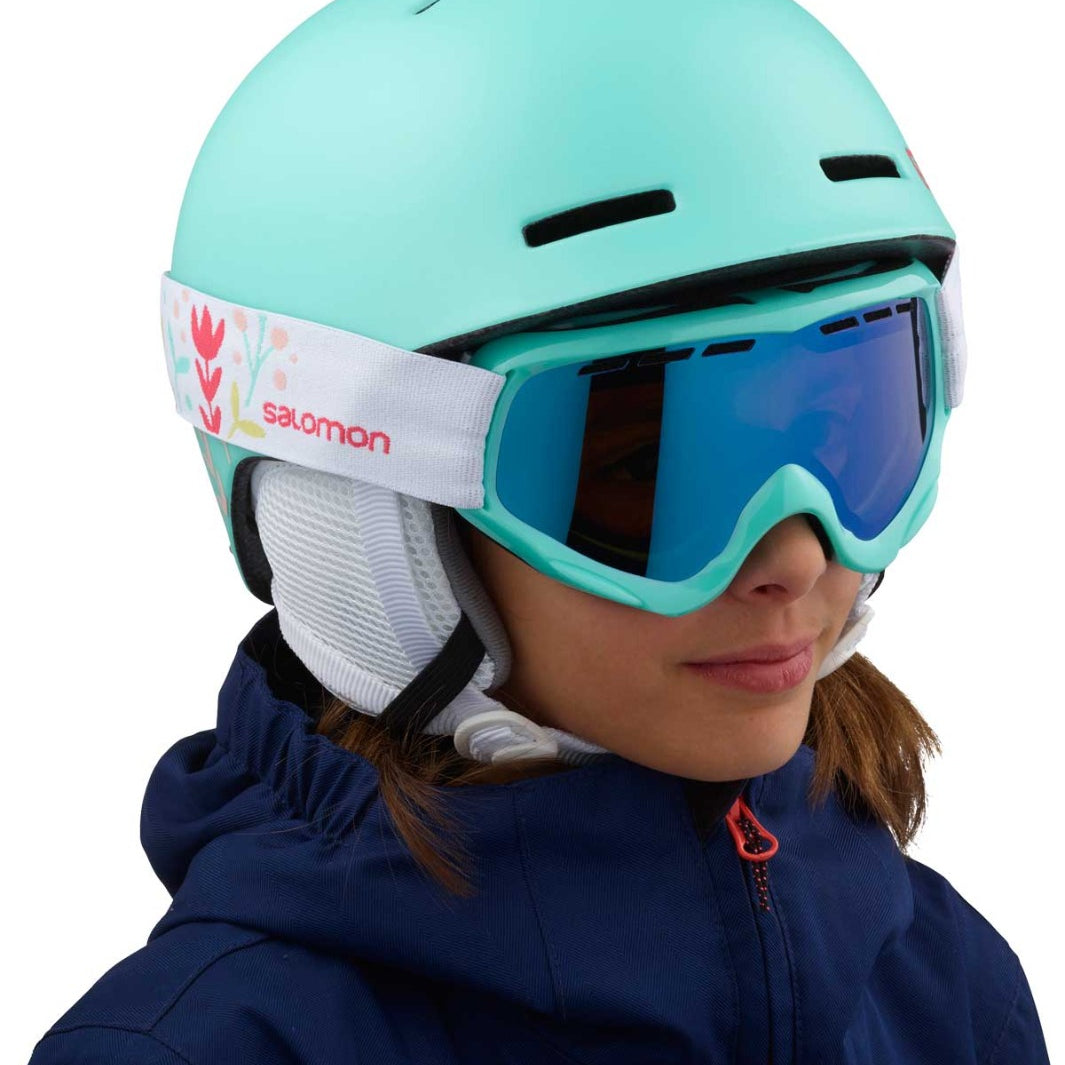 Salomon Juniors' Grom Helmet 2020 - A mint green helmet with a white strap and red logo on the side.