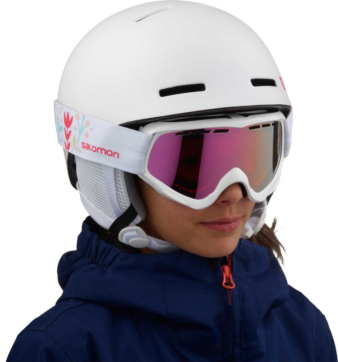 Salomon Juniors' Grom Helmet 2020 - A white helmet with a pink logo on the side and a chin strap.