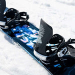 Lib Tech Skate Banana Snowboard 2024 B-Grade - A blue snowboard with a white logo and pink lettering on its bottom, lying flat in the snow.
