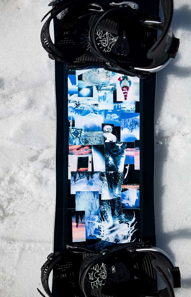 Lib Tech Skate Banana Snowboard 2024 B-Grade - A black snowboard with a collage of various images on its bottom, including a person in red pants and white top, trees, and mountains.