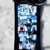 Lib Tech Skate Banana Snowboard 2024 B-Grade - A black snowboard with a collage of various images on its bottom, including a person in red pants and white top, trees, and mountains.