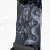 Lib Tech Skunk Ape Camber Snowboard 2025 - Black snowboard with a white and blue abstract design on top of a snowy mountain landscape.