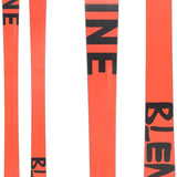Line Blend Skis 2024 - A pair of skis with a coral-colored base and black lettering that reads "LINE" on top, featuring a geometric pattern in the same color scheme.