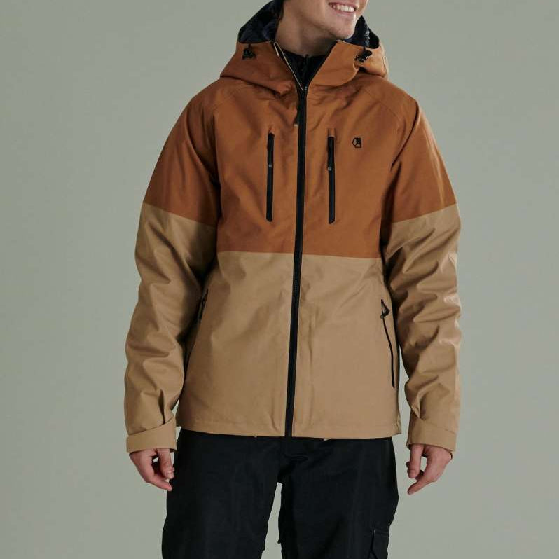 Liquid Anton Pro Stretch Jacket - A tan jacket with a black zipper, two zippered pockets on the front and one on the left arm.