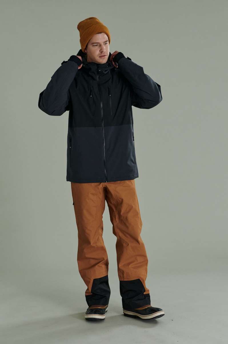 Liquid Anton Pro Stretch Jacket 2022-2023 - A black jacket with a high collar and zippered pockets on either side.