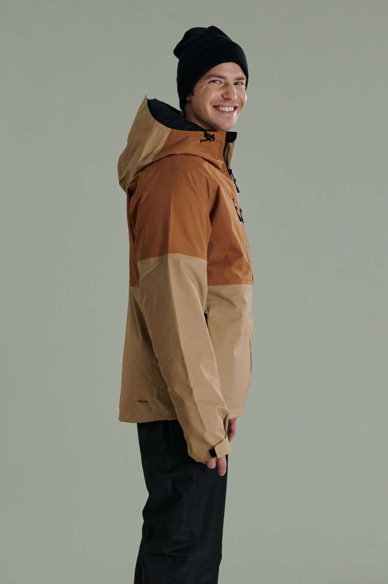 Liquid Anton Pro Stretch Jacket - A tan-colored jacket with a black zipper and black drawstring at the hood.