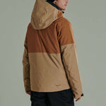 Liquid Anton Pro Stretch Jacket 2022-2023 - A tan and brown color-blocked jacket with a hood, worn by a model facing away from the camera.