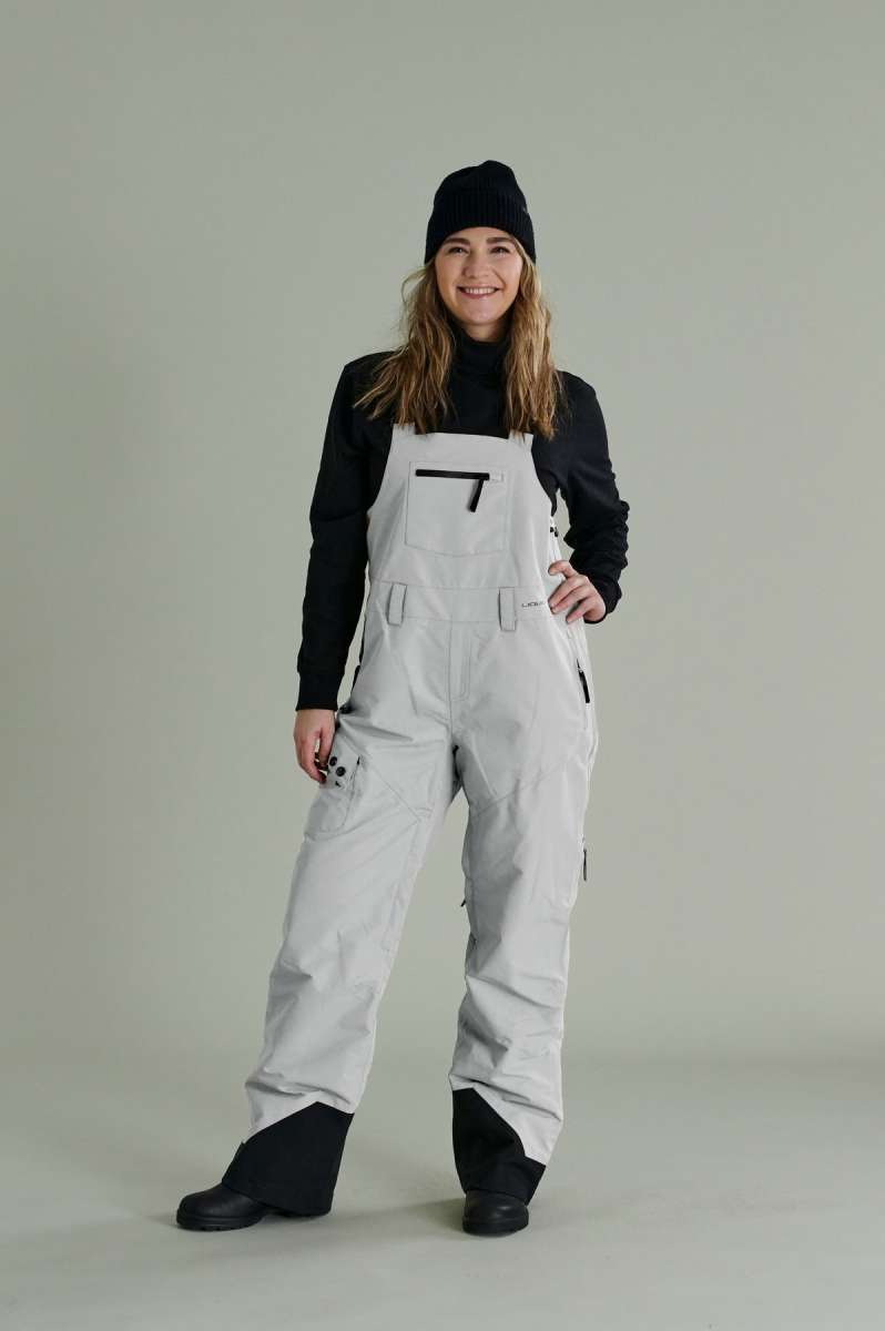 Liquid Ladies Celeste Insulated Bib 2022-2023 - A bib-style snowsuit with a black and white patterned design, featuring a zippered front and adjustable straps.