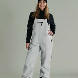 Liquid Ladies Celeste Insulated Bib 2022-2023 - A bib-style snowsuit with a black and white patterned design, featuring a zippered front and adjustable straps.