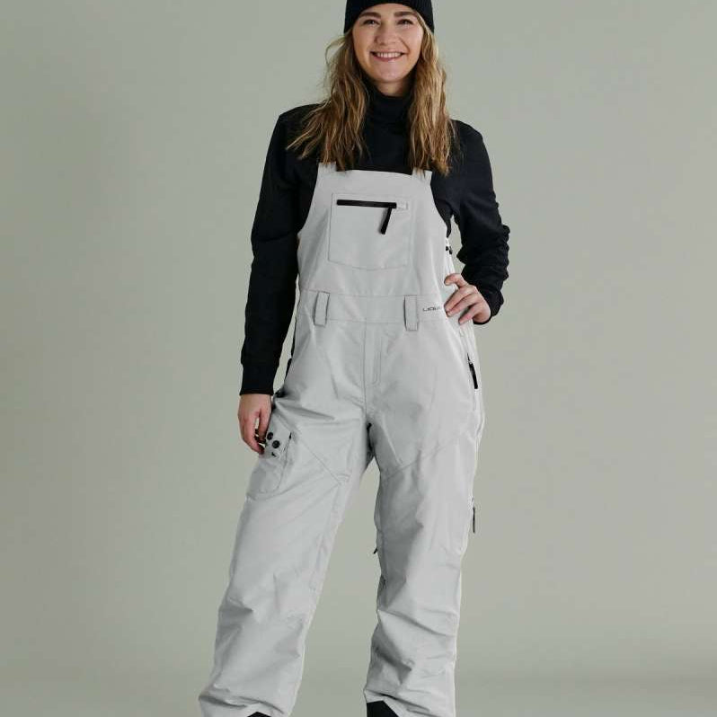 Liquid Ladies Celeste Insulated Bib 2022-2023 - A bib-style snowsuit with a black and white patterned design, featuring a zippered front and adjustable straps.