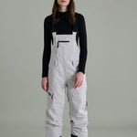 Liquid Ladies Celeste Insulated Bib 2022-2023 - A bib-style snowsuit with a black and white color scheme, featuring a subtle pattern of small, dark dots on the upper portion.