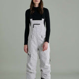 Liquid Ladies Celeste Insulated Bib 2022-2023 - A bib-style snowsuit with a black and white color scheme, featuring a subtle pattern of small, dark dots on the upper portion.