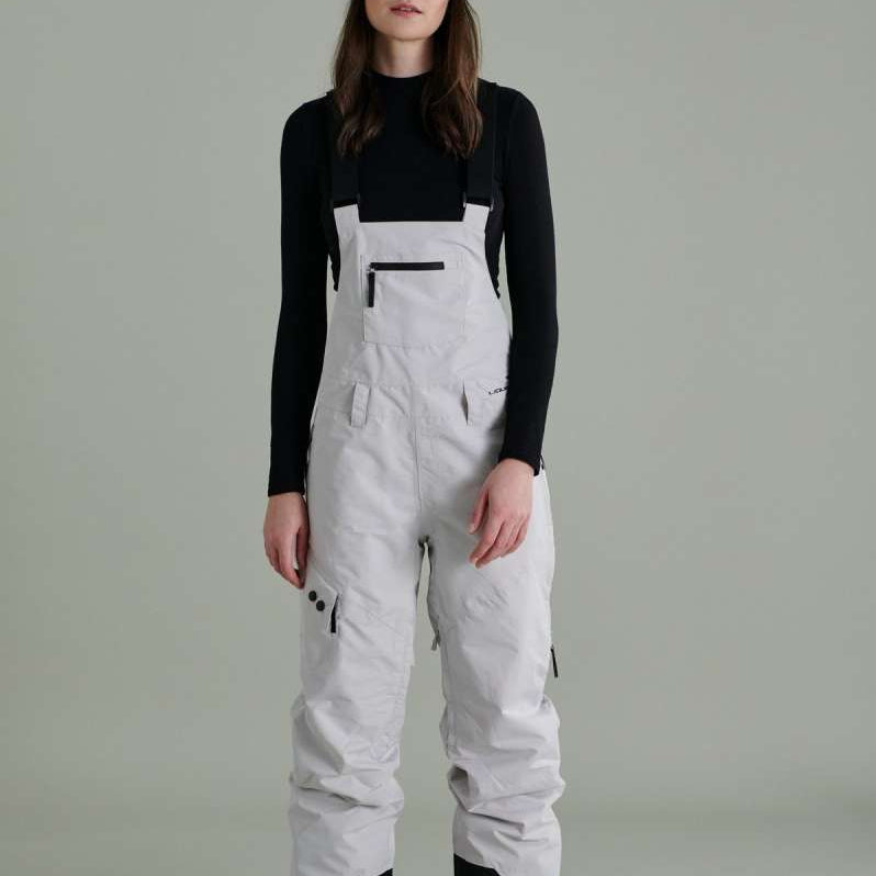 Liquid Ladies Celeste Insulated Bib 2022-2023 - A bib-style snowsuit with a black and white color scheme, featuring a subtle pattern of small, dark dots on the upper portion.