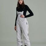 Liquid Ladies Celeste Insulated Bib 2022-2023 - A black and white bib-style snowsuit with a zippered front, adjustable straps, and two side pockets.