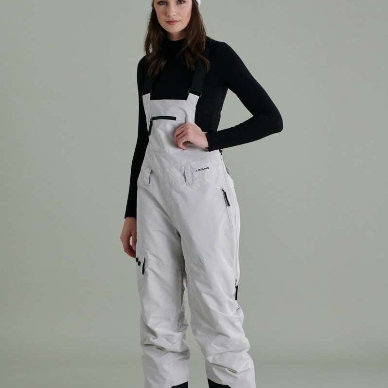 Liquid Ladies Celeste Insulated Bib 2022-2023 - A black and white bib-style snowsuit with a zippered front, adjustable straps, and two side pockets.