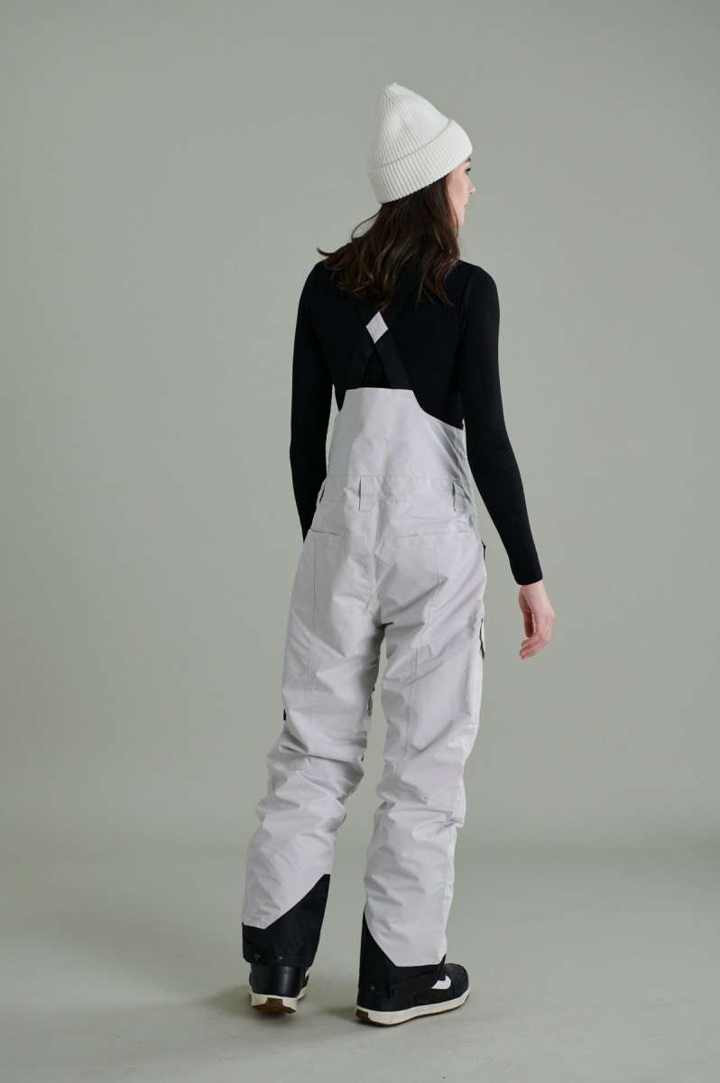 Liquid Ladies Celeste Insulated Bib 2022-2023 - A bib-style snow pant with a black and white patterned design, featuring a zippered fly and adjustable straps.