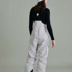 Liquid Ladies Celeste Insulated Bib 2022-2023 - A bib-style snow pant with a black and white patterned design, featuring a zippered fly and adjustable straps.