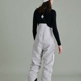 Liquid Ladies Celeste Insulated Bib 2022-2023 - A bib-style snow pant with a black and white patterned design, featuring a zippered fly and adjustable straps.