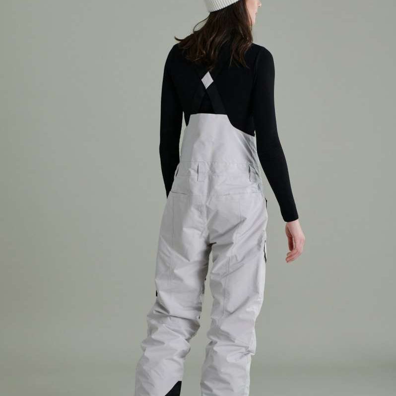 Liquid Ladies Celeste Insulated Bib 2022-2023 - A bib-style snow pant with a black and white patterned design, featuring a zippered fly and adjustable straps.