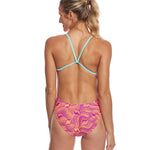 Nike Swim Ladies' Far Out Cut-Out Tank One-Piece Swimsuit - A pink one-piece swimsuit with cut-outs and a tank-style top, featuring a geometric pattern on the fabric.