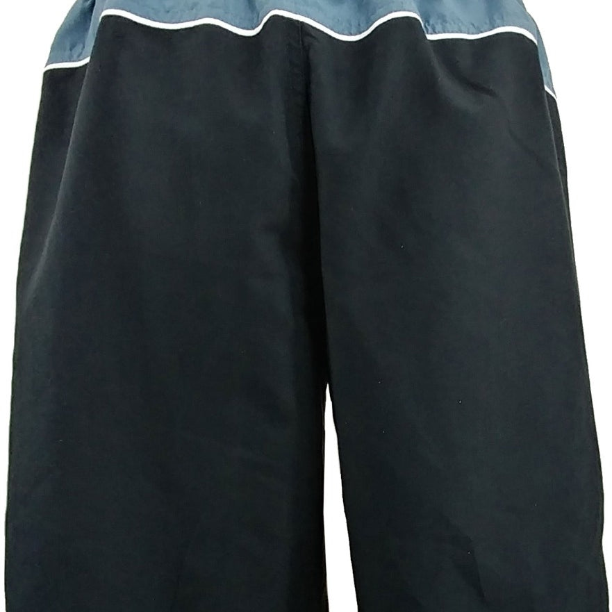 Nike Men's Color Surge 9" Volley Shorts - A pair of black shorts with a white Nike logo on the left leg and a small white checkmark above it.