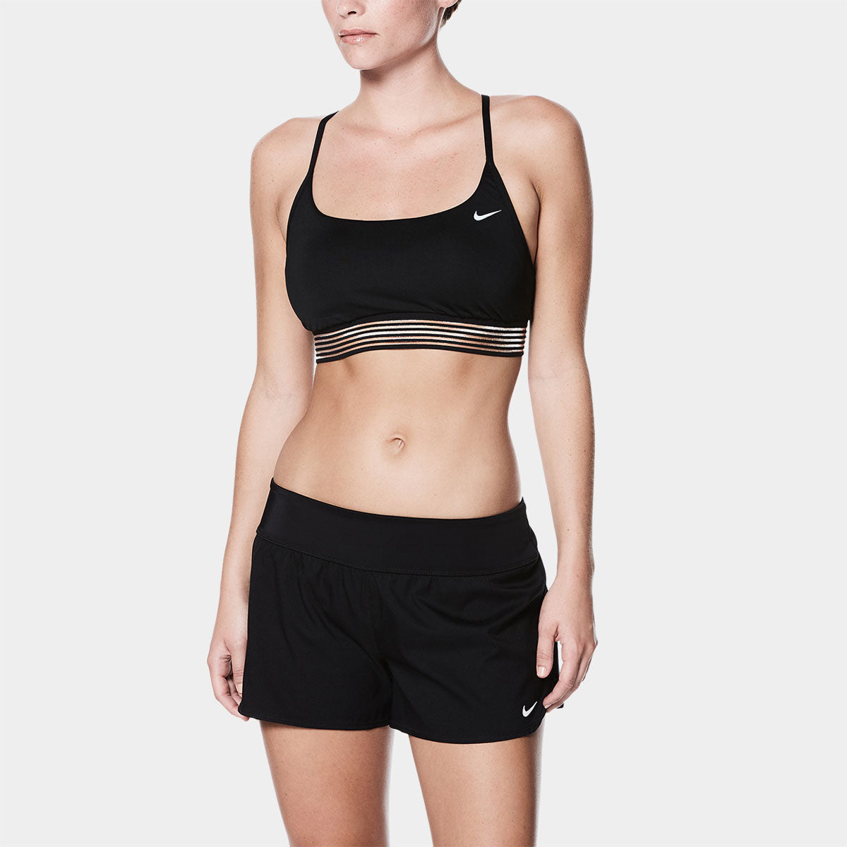 Nike Swim Ladies' Solid Element Board Shorts Bottom Two-Piece Swimsuit - A black two-piece swimsuit with a solid pattern, featuring Nike's iconic swoosh logo on the left hip of the shorts.