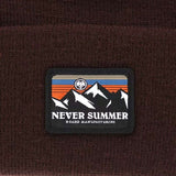 Never Summer - A beanie with a retro sunset design on the cuff, featuring orange and blue stripes.