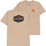 Never Summer Workwear 2 Short Sleeve Tee 2024 - A tan short-sleeved t-shirt with a small orange logo on the left chest featuring three trees and the words "NEVER SUMMER" in black.