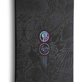 Nidecker Women's Venus Plus Snowboard 2024 - A black snowboard with a floral pattern and a circular logo featuring the word "Venus" in cursive script at the top center.