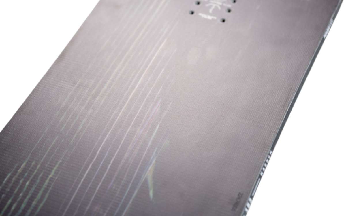 Nitro Magnum Snowboard 2024 - A black snowboard with a subtle wood grain pattern on its surface.