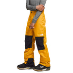 North Face Boys Freedom Insulated Pant 2024 - A pair of yellow and black insulated ski pants with a white logo on the left thigh.
