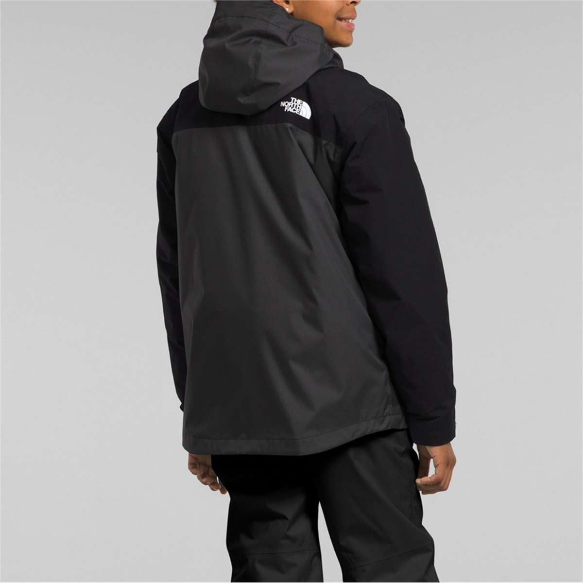 North Face Boys Freedom Triclimate Jacket 2024 - A black jacket with a white logo on the upper back.