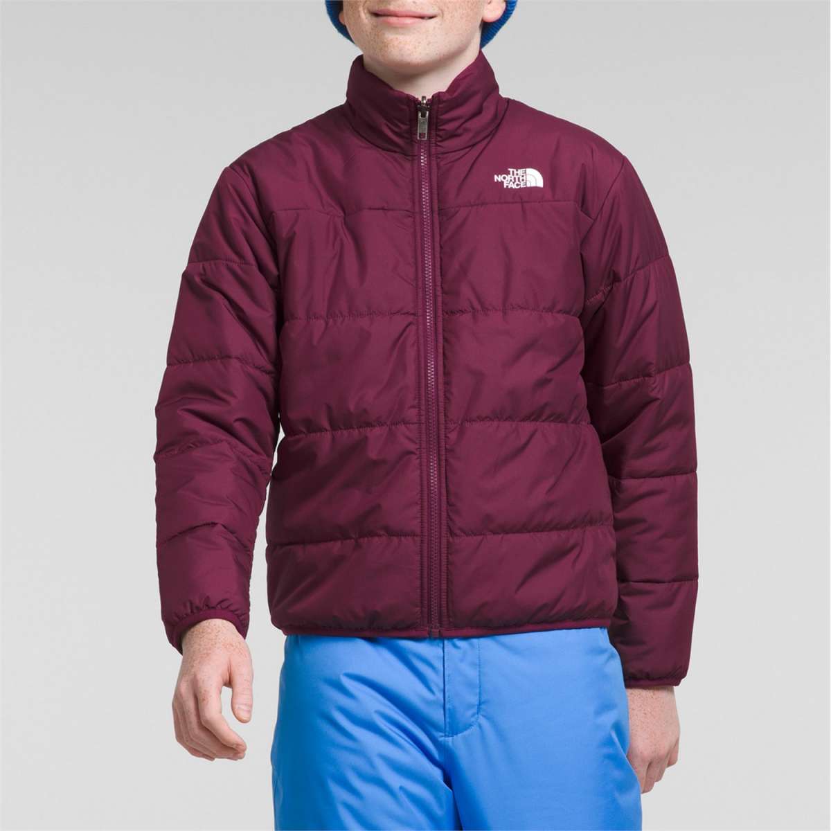 North Face Boys Freedom Triclimate Jacket 2024 - A dark-colored, quilted jacket with a white logo on the left chest area.