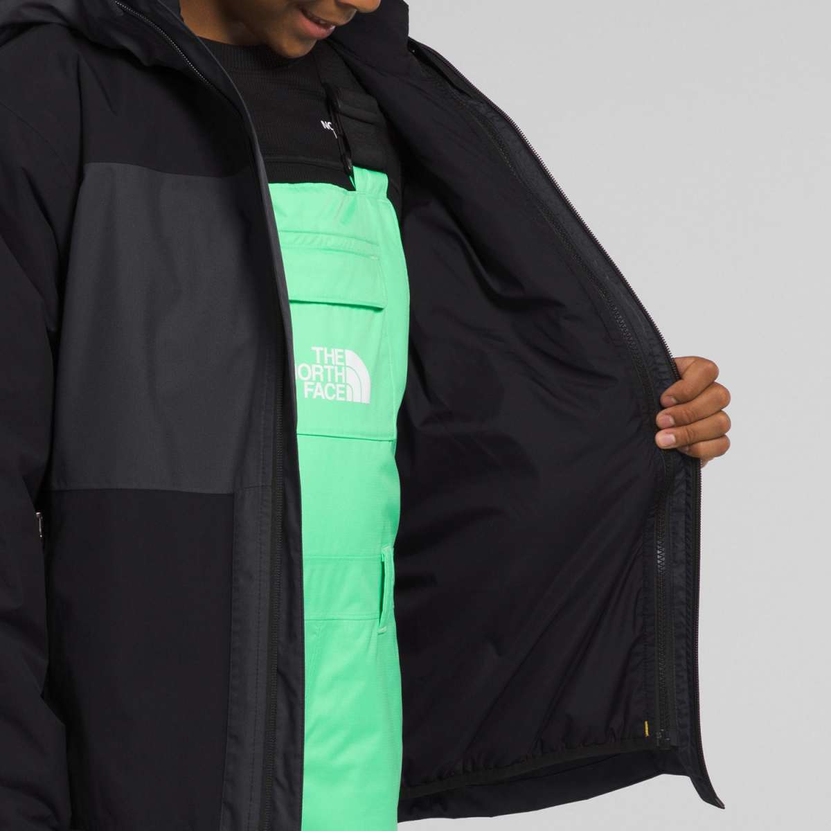 North Face Boys Freedom Triclimate Jacket 2024 - A black jacket with a white logo on the chest.