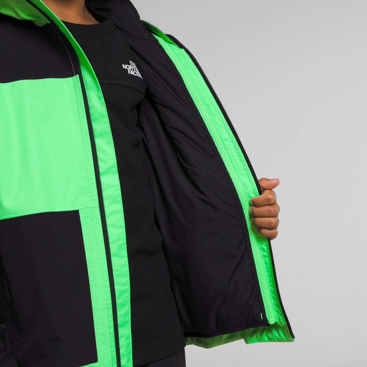 North Face Boys Freedom Triclimate Jacket 2024 - A black and green jacket with a white logo on the left chest.